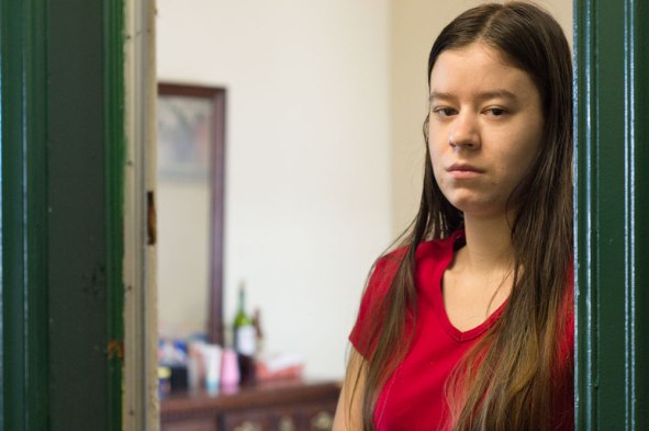 Danielle Parenteau stands in the door frame of her 100-square-foot studio in downtown San Francisco. Photo by Sara Bloomberg/Bay News Rising