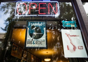 Posters promoting live jazz and an in-house gallery festoon the front window of Bird & Beckett Books and Records in Glen Park. (Photo by Ekevara Kitpowsong/ Bay News Rising)