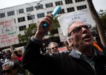 Protesters assemble picket signs slamming Uber business practices outside company headquarters on Market Street June 22. (Photo by Khaled Sayed/Bay News Rising)
