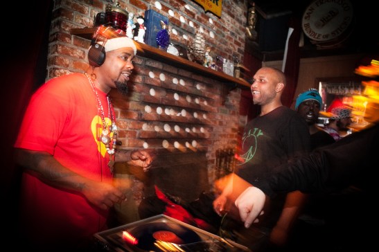 (L-R) D.J. “BeatsMe” Milan Hawthorne, spins his mix beats while D.J. Shawn Castello enjoys the music next to him at The Riptide bar in Sunset District, San Francisco on Thursday, July 23, 2015. (Photo by Ekevara Kitpowsong/Bay News Rising)