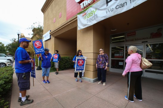 Postal workers Michael Rodriguez and Silvia Montes explain their concerns to passersby outside a Pleasant Hill Staples on Thursday, July 9. (Emilia Rosales/Bay News Rising)