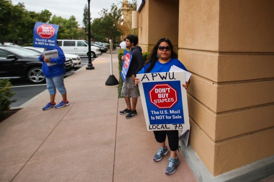 Silvia Montes, union postal worker since 1989, pickets outside a Staples store in Pleasant Hill on Thursday, July 9. (Emilia Rosales/Bay News Rising)