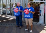 Alan Menjivar (right) and Michael Foley (left) picket outside a Staples store in San Rafael on Tuesday, July 28. (Emilia Rosales/Bay News Rising)