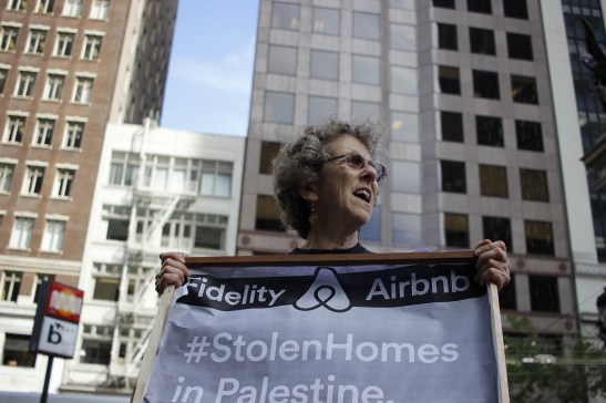 Karen Platt, a member of Jewish Voice for Peace, shouts a chant urging Fidelity to stop investing in Airbnb at their building in downtown San Francisco on Friday, June 3, 2016. (Photo by Grady Penna / Bay News Rising)