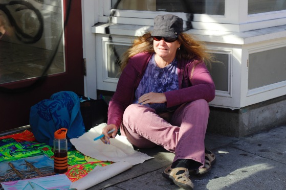 Local painter Cynthia Jones lays out her artwork on the sidewalk to sell to passers-by on Haight Street on Saturday, June 25, 2016. (Photo by Grady Penna / Bay News Rising)