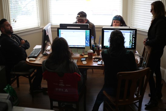 Six of the 10 Homeless Youth Alliance staff sit at the dining room table of a Haight resident, which serves as their temporary office space of two years, on June 22, 2016. Photo by Kelsey Lannin